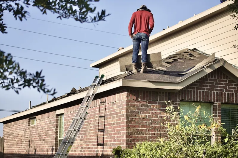 Professional roofer working on a residential roof in College Hills Historic District